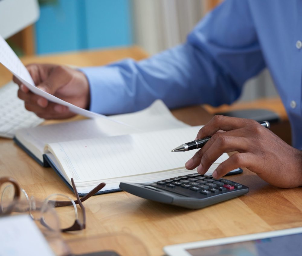 Close-up image of financial managers working with reports